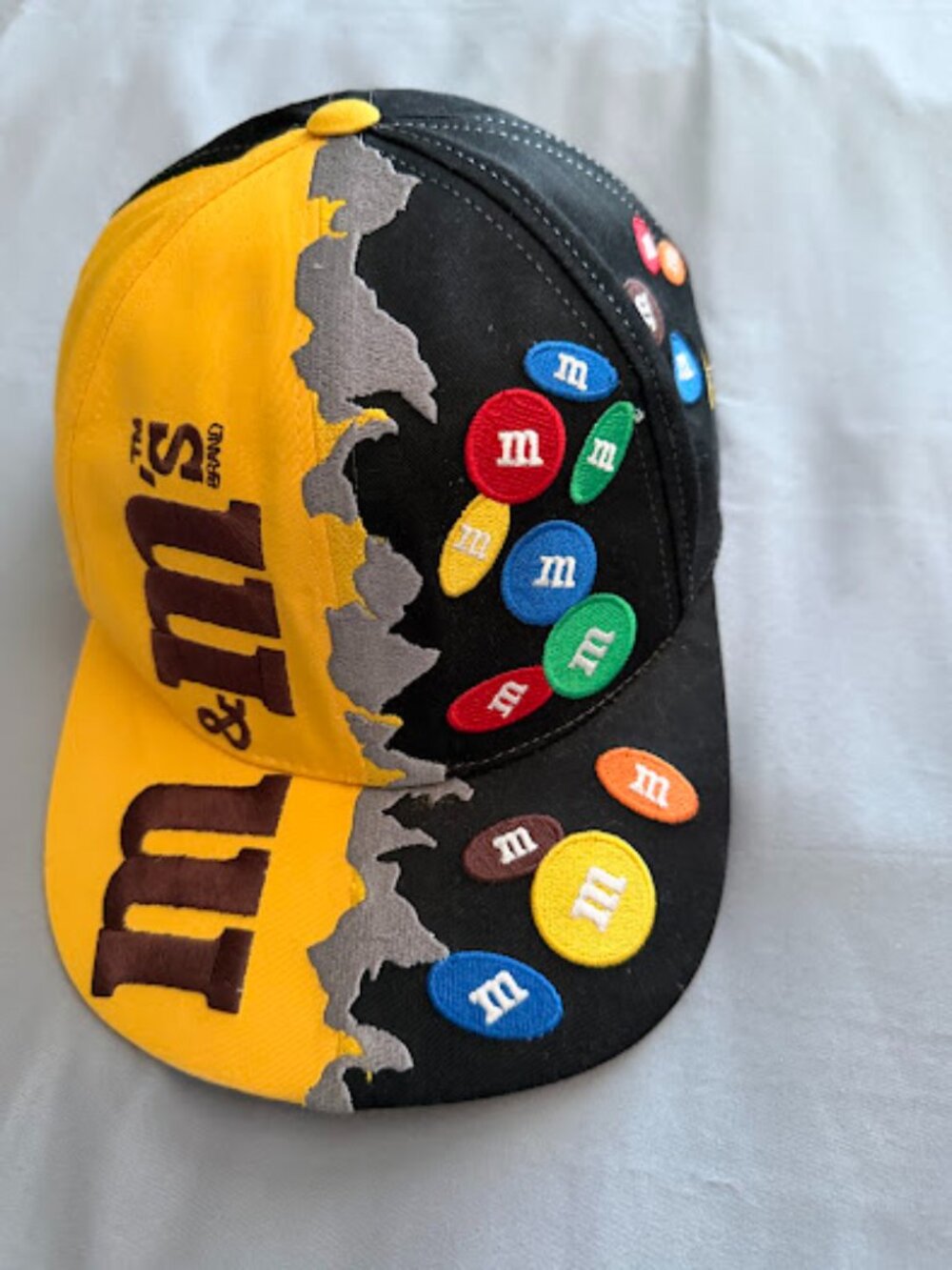 vibrant  cap featuring promotional branding for M&M's